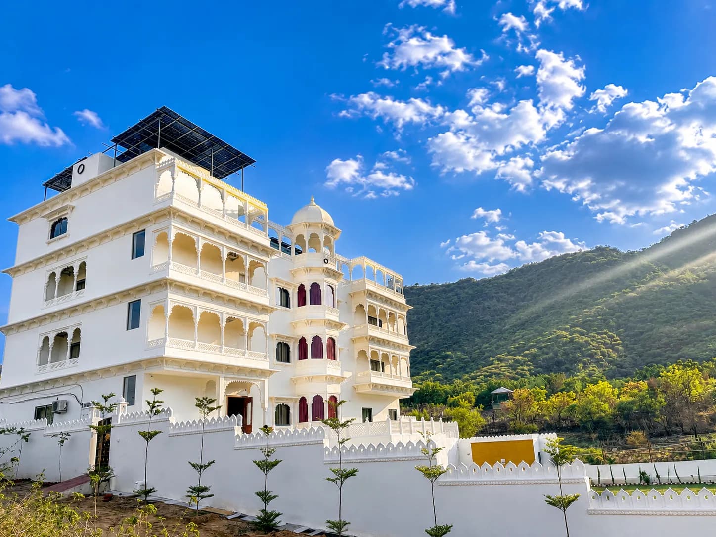 The villa's white facade glowing in golden evening light